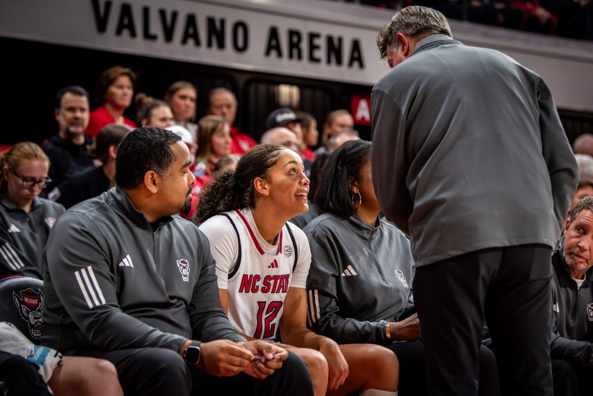 Junior forward Khamil Pierre smiles while talking to head coach Wes Moore during the game against Maine in Reynolds Coliseum on Tuesday, Nov. 11, 2025. The Wolfpack defeated the Black Bears 66-47.