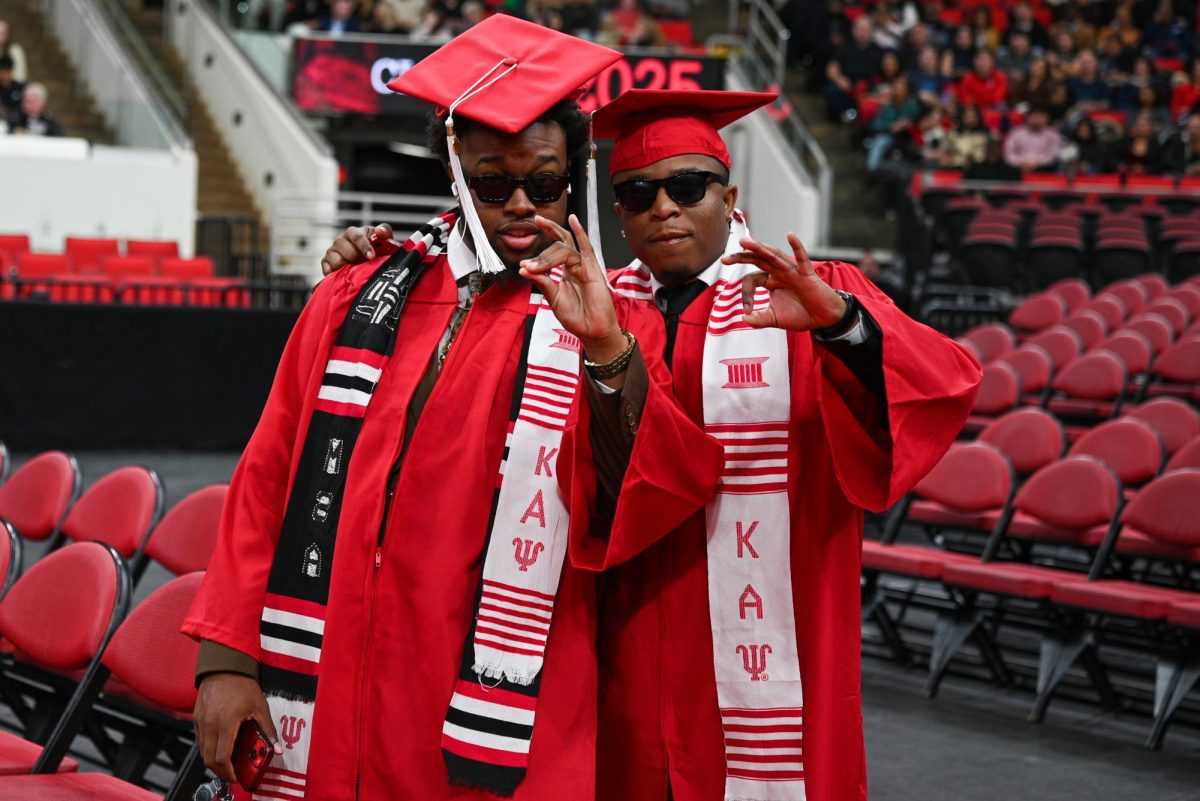 Graduates Zaire Kenney, studying business administration, and Isaiah Gadson, studying social work, pose for a photo during the Fall Commencement Ceremony in the Lenovo Center on Saturday, Dec. 13, 2025.