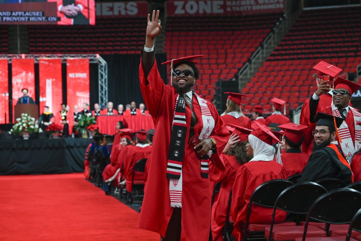 Zaire Kenney, a fourth-year studying business administration and a brother of the Kappa Xi chapter of Kappa Alpha Psi Fraternity, poses in celebration during the Fall Commencement Ceremony in the Lenovo Center on Saturday, Dec. 13, 2025. The Fall Commencement awarded 3,498 degrees to 3,384 graduates.