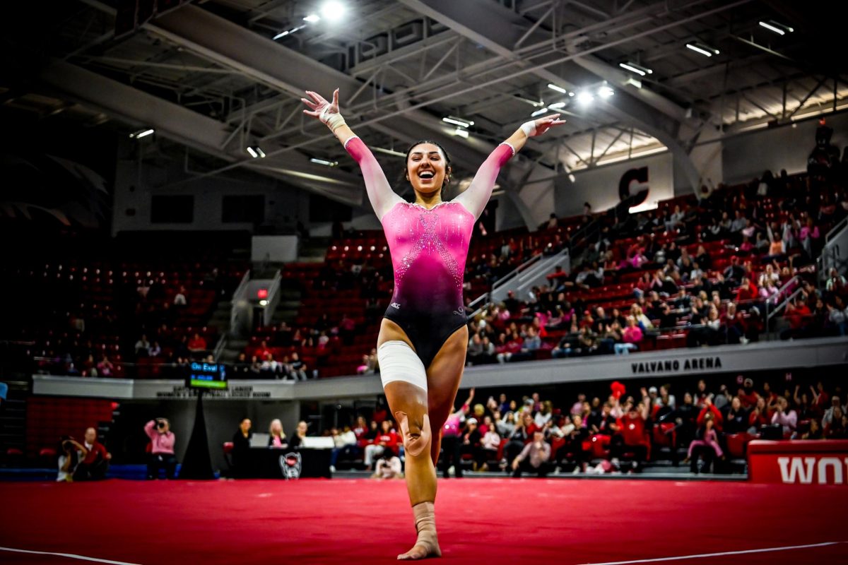 Junior Meg Adler sticks the landing of her floor routine during NC State's home gymnastics meet against the Pitt Panthers in Reynolds Coliseum on Saturday, Feb. 8, 2025. Adler scored a 9.825 in the floor exercise. The Wolfpack beat the Panthers 196.475-193.600.