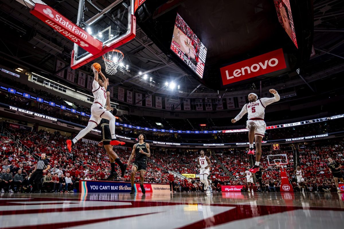 Senior guard Quadir Copeland catches an alley-oop from senior guard Tre Holloman during the game against Wake Forest at the Lenovo Center on Wednesday, Dec. 31, 2025. The Wolfpack defeated the Demon Deacons 70-57.