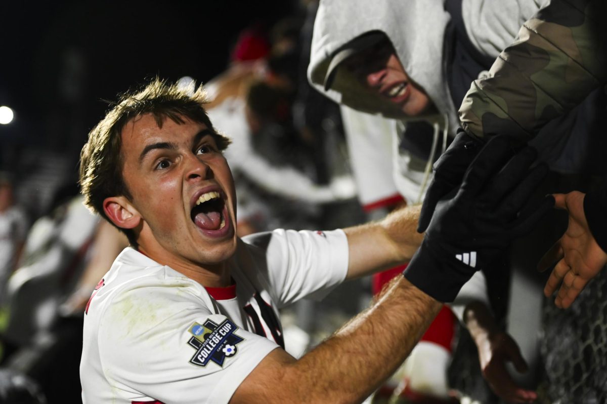 Senior midfielder Taig Healy celebrates with fans after winning the NCAA Men's College Cup Semifinal match versus St. Louis at WakeMed Soccer Park on Friday, Dec. 12, 2025. Healy scored one goal for NC State. The Wolfpack beat the Billikens 2-1.