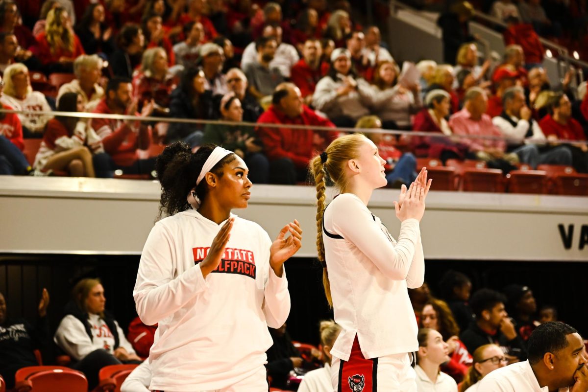 Junior center Mallory Collier and sophomore forward Tilda Trygger clap for their teammates during the game against Seton Hall in Reynolds Coliseum on Sunday, Dec. 7, 2025. The Wolfpack defeated the Pirates 61-53.