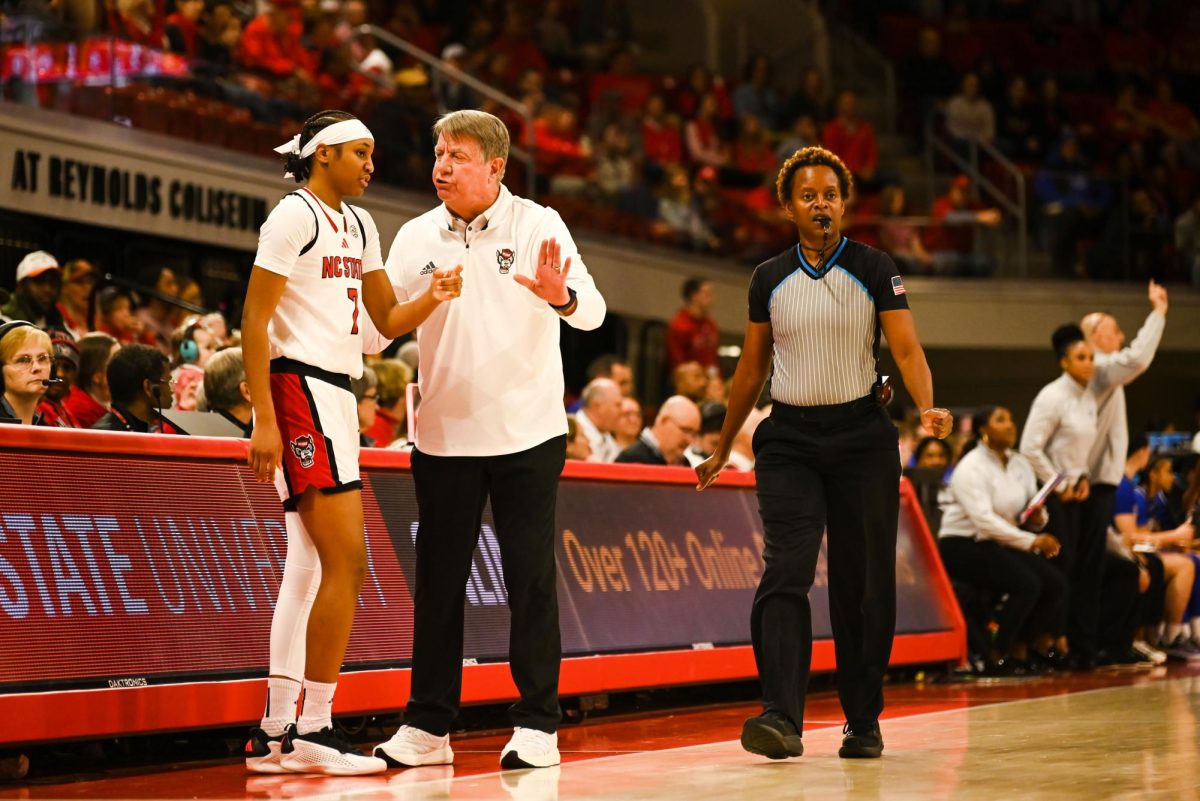 Freshman guard Destiny "Ky'She" Lunan and head coach Wes Moore talk during the game against Seton Hall in Reynolds Coliseum on Sunday, Dec. 7, 2025. Lunan scored five points and made two rebounds. The Wolfpack defeated the Pirates 61-53.