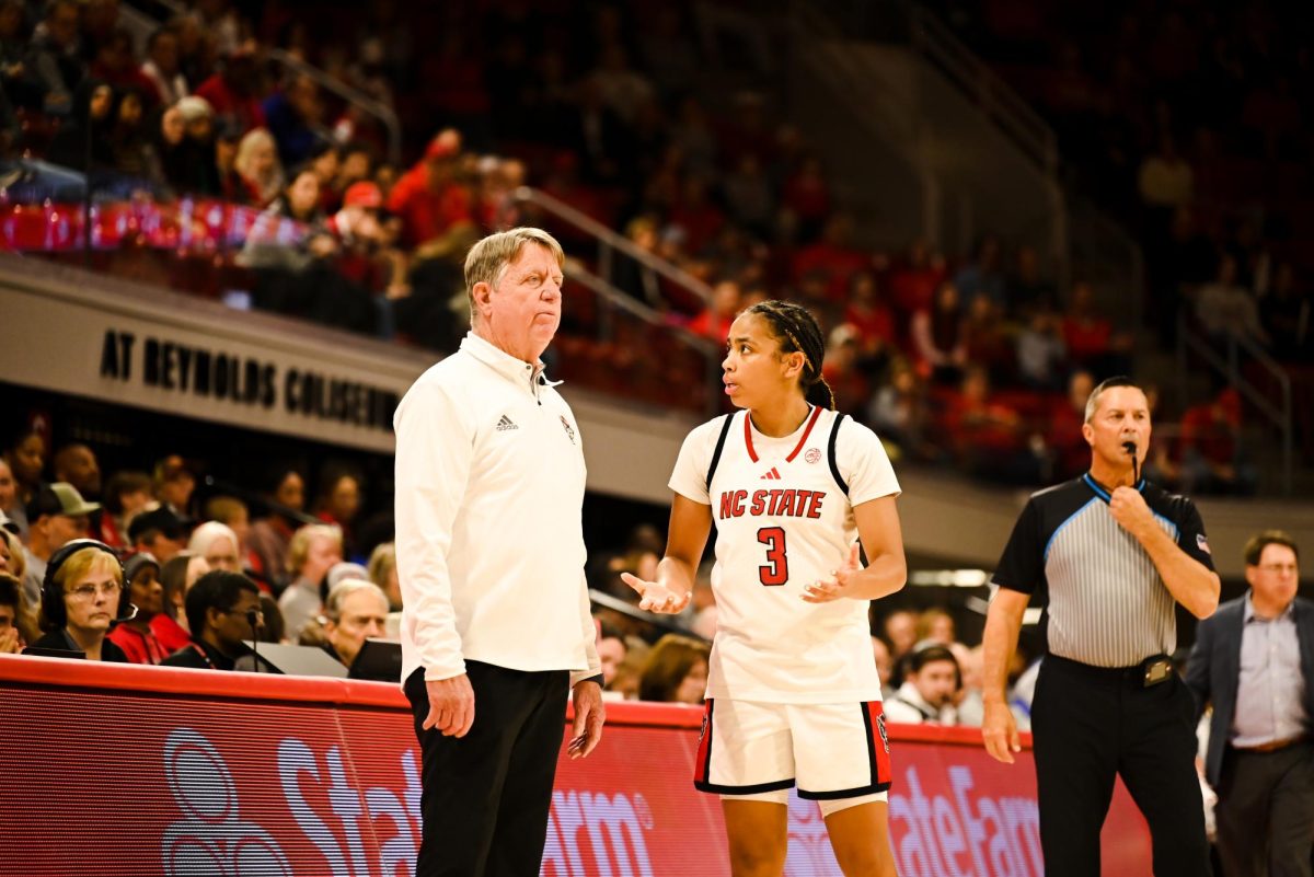 Head coach Wes Moore and sophomore guard Zamareya Jones talk during the game against Seton Hall in Reynolds Coliseum on Sunday, Dec. 7, 2025. Jones scored 12 points. The Wolfpack defeated the Pirates 61-53.
