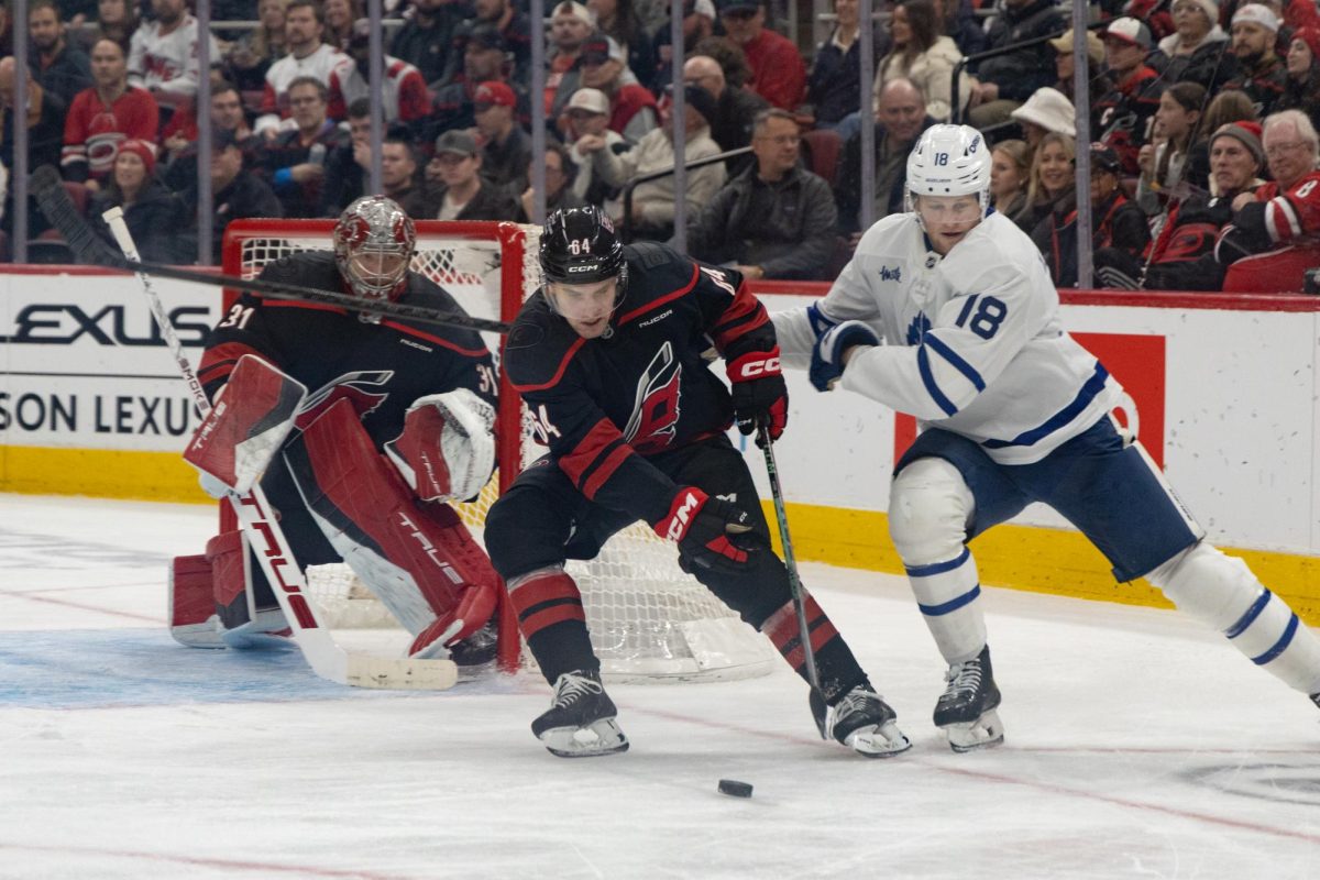 Carolina Hurricanes defenseman Joel Nystrom fights for the puck during the game against the Toronto Maple Leafs at the Lenovo Center on Thursday, Dec. 4, 2025. Nystrom had 13:21 of ice time during the game. Toronto beat Carolina 5-1.