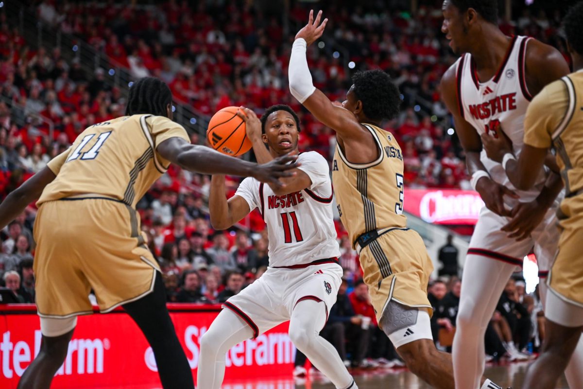 Senior guard Quadir Copeland struggles to push past Georgia Tech’s defense at the Lenovo Center on Saturday, Jan. 17, 2026. Copeland scored a total of 16 points. The Wolfpack fell to the Yellow Jackets 74-78.
