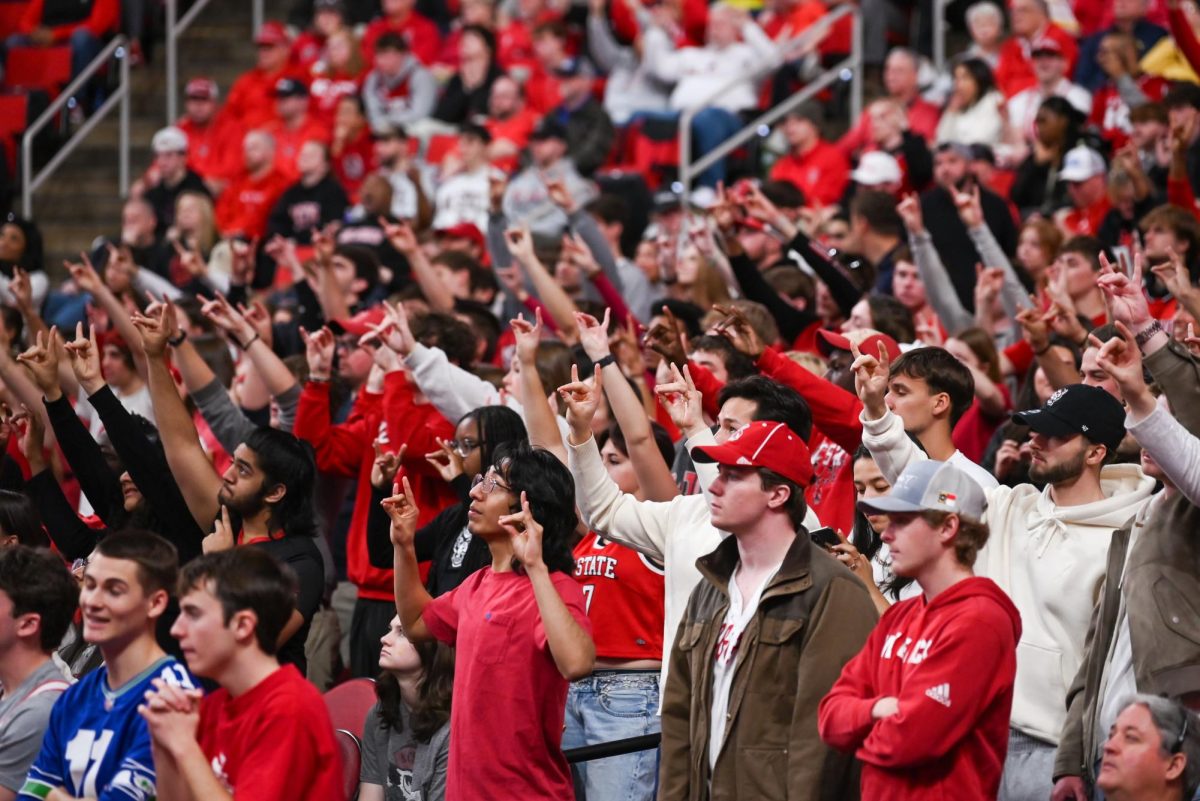 NC State’s student section holding up wolfies for an NC State free throw during the game against Georgia Tech at the Lenovo Center on Saturday, Jan. 17, 2026. NC State had a total of 32 rebounds and 13 steals. The Wolfpack fell to the Yellow Jackets 74-78.