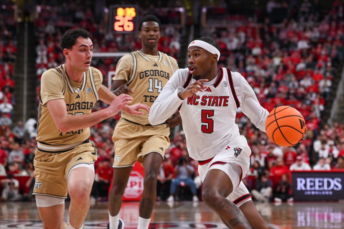 Senior guard Tre Holloman dribbles past Georgia Tech’s defense at the Lenovo Center on Saturday, Jan. 17, 2026. Holloman scored a total of six points. The Wolfpack fell to the Yellow Jackets 74-78.