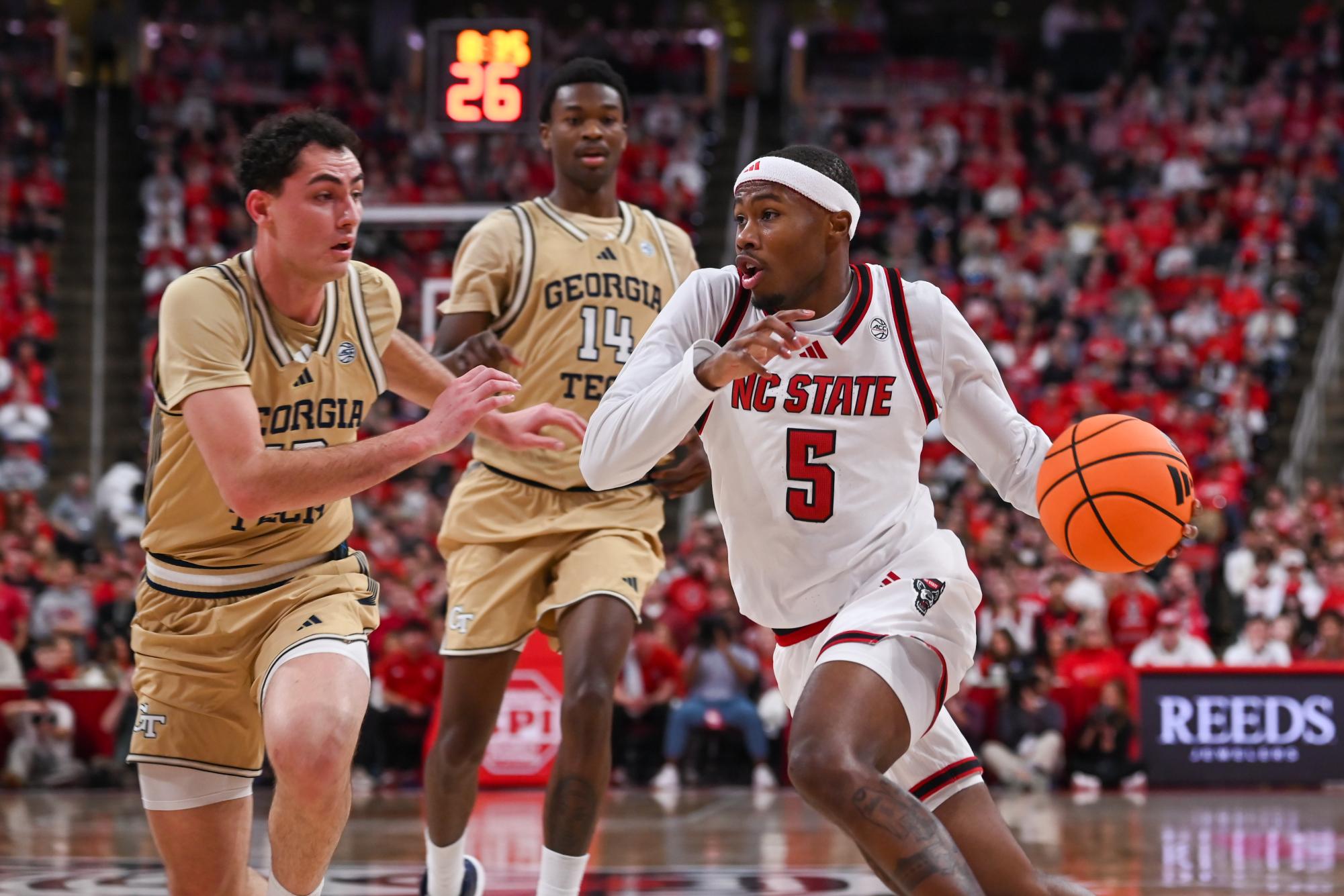 Senior guard Tre Holloman dribbles past Georgia Tech’s defense at the Lenovo Center on Saturday, Jan. 17, 2026. Holloman scored a total of six points. The Wolfpack fell to the Yellow Jackets 74-78.