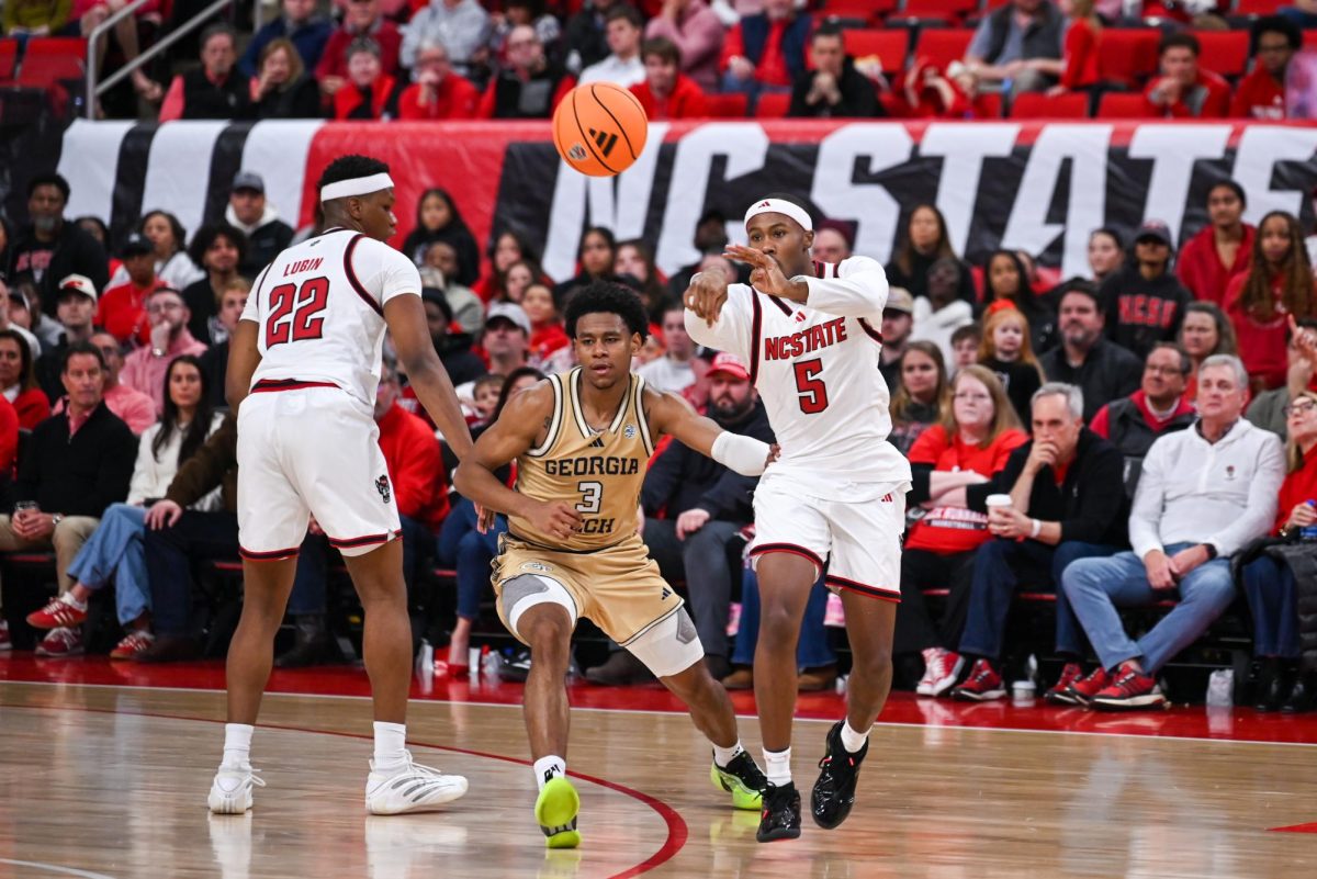 Senior guard Tre Holloman passes the ball during the game against Georgia Tech at the Lenovo Center on Saturday, Jan. 17, 2026. Holloman went 3-4 in free throws. The Wolfpack fell to the Yellow Jackets 74-78.