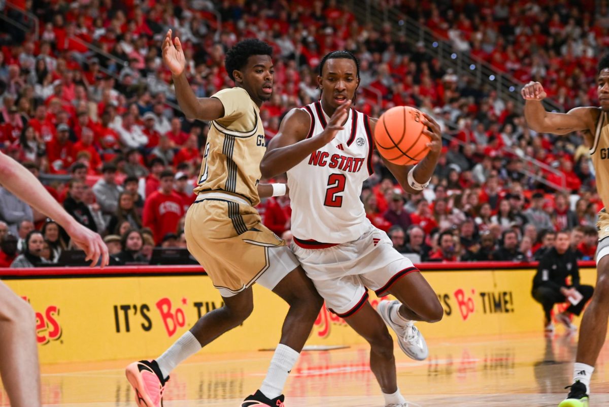 Sophomore guard Paul McNeil Jr. pushes past a Georgia Tech defender at the Lenovo Center during the game against Georgia Tech on Saturday Jan. 17, 2026. McNeil scored a total of 12 points. The Wolfpack fell to the Yellow Jackets 74-78.
