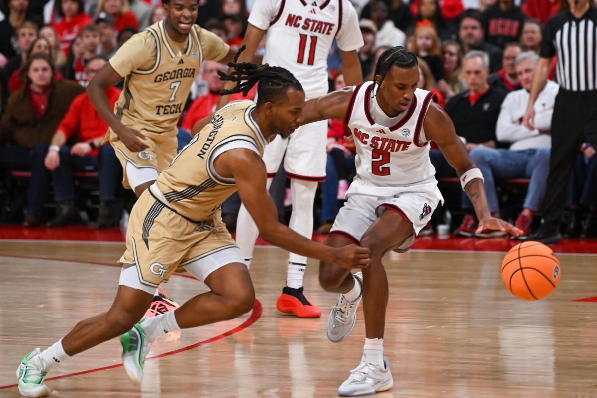 Sophomore guard Paul McNeil Jr. and Georgia Tech player dash for a stray ball during the game against Georgia Tech at the Lenovo Center on Saturday Jan. 17, 2026. McNeil scored a total of 12 points. The Wolfpack fell to the Yellow Jackets 74-78.