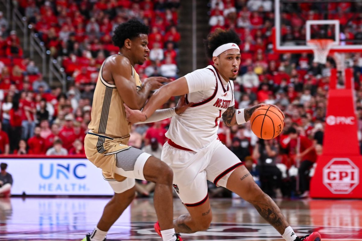 Senior forward Darrion Williams dashes past a Georgia Tech player during the game against Georgia Tech at the Lenovo Center on Saturday Jan. 17, 2026. Williams scored seven points and had five assists. The Wolfpack fell to the Yellow Jackets 74-78.
