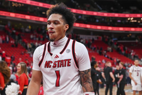 Senior forward Darrion Williams disappointingly walks off the court after the game against Georgia Tech at the Lenovo Center on Saturday Jan. 17, 2026. Williams scored seven points and had five assists. The Wolfpack fell to the Yellow Jackets 74-78.