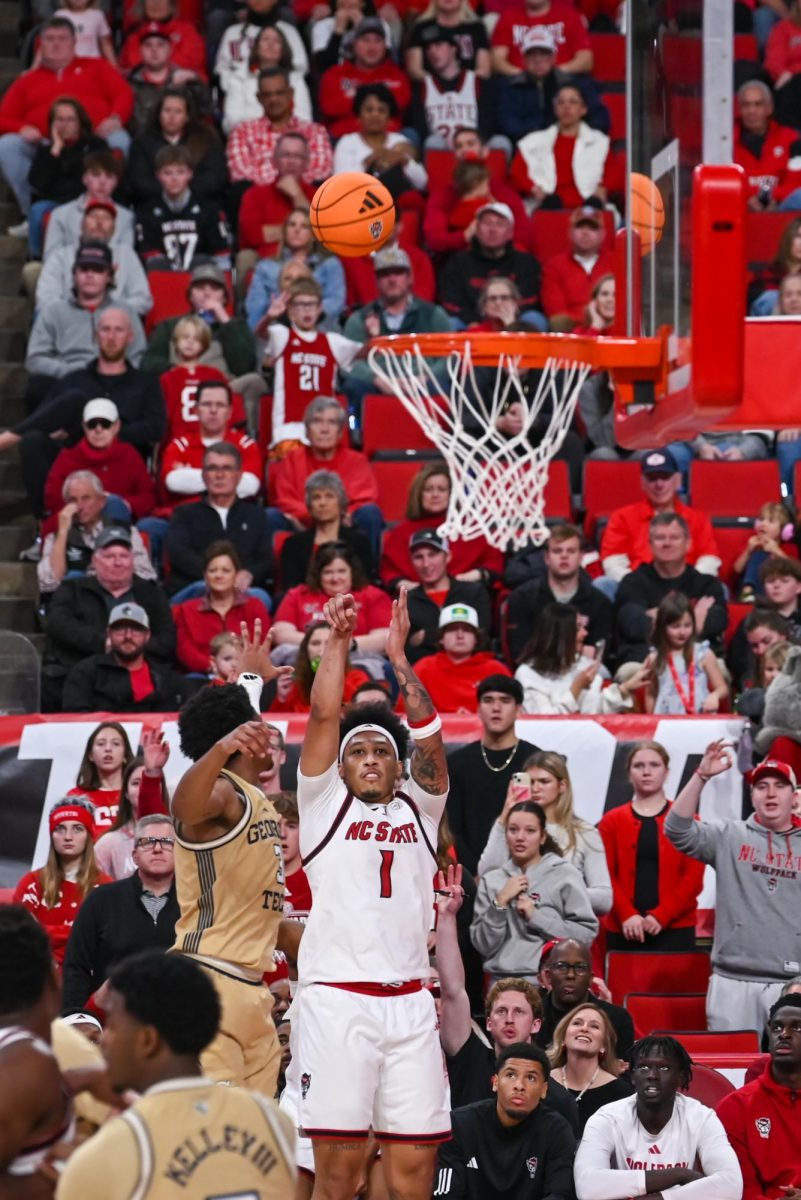 Senior forward Darrion Williams shoots a three-pointer during the game against Georgia Tech at the Lenovo Center on Saturday Jan. 17, 2026. Williams scored seven points and had five assists. The Wolfpack fell to the Yellow Jackets 74-78.