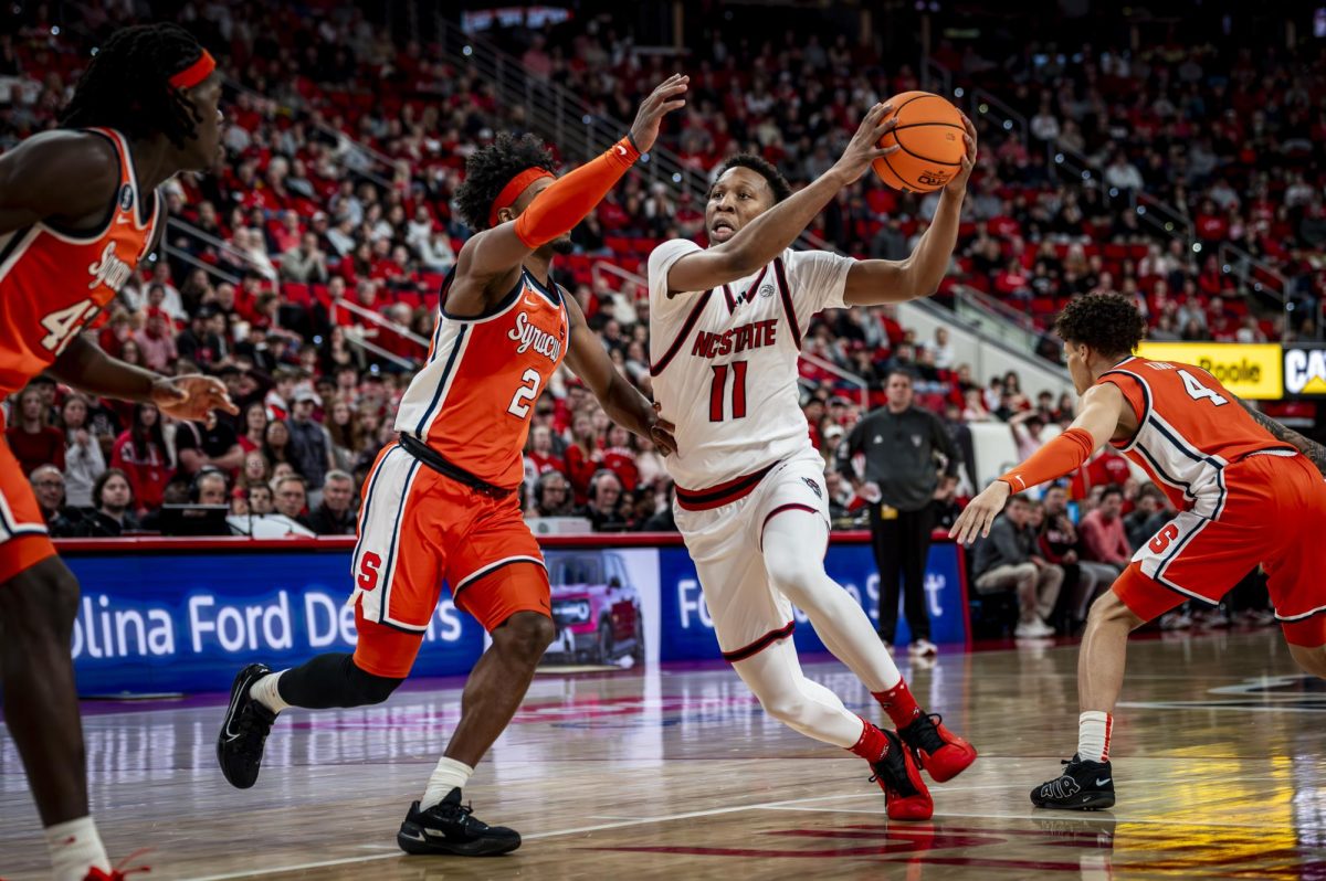 NC State senior guard Quadir Copeland (11) drives to the basket during the game against Syracuse in the Lenovo Center on Tuesday, Jan. 27, 2026. Copeland had 19 points and added nine assists. The Wolfpack defeated the Orange 88-68.