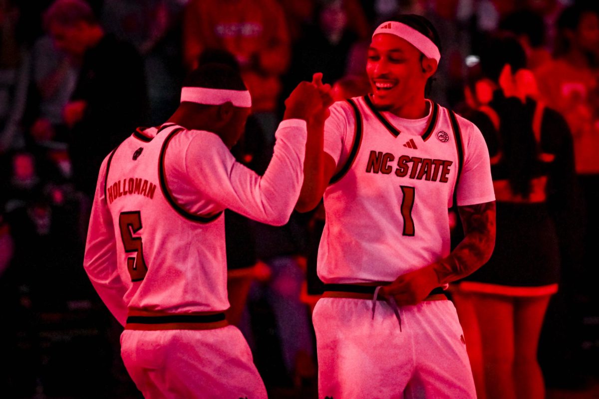 Senior forward Darrion Williams dances with senior guard Tre Holloman before the game against Syracuse at the Lenovo Center on Tuesday, Jan. 27, 2026. The Wolfpack defeated the Orange 88-68. 