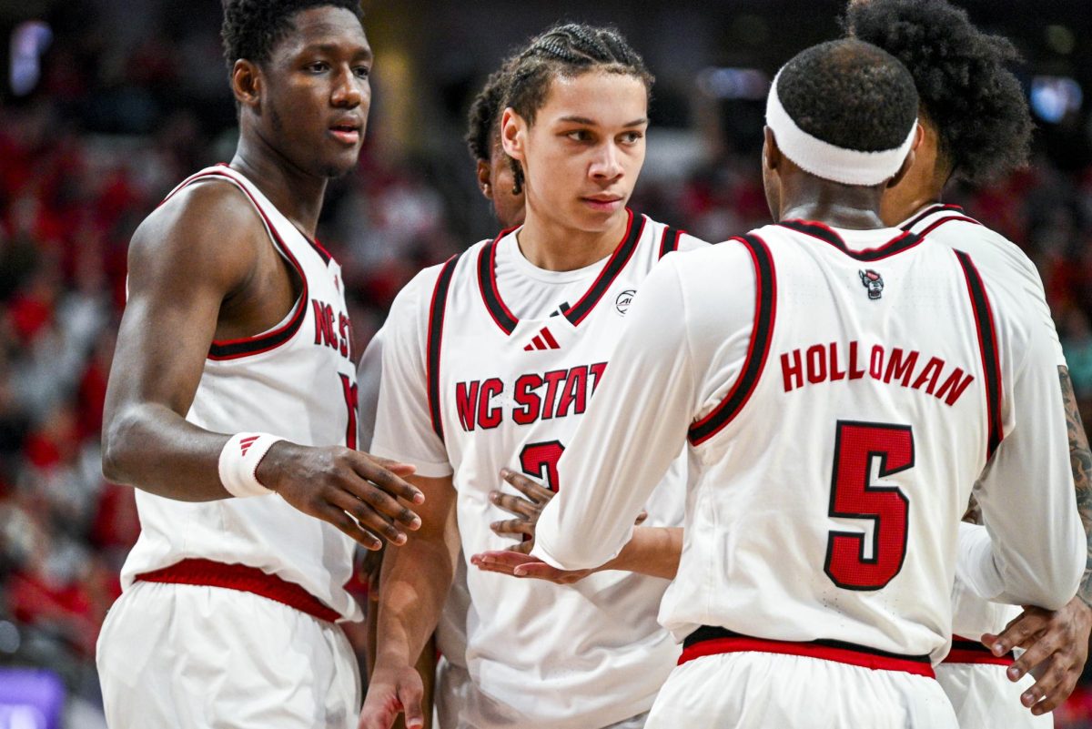 Freshman guard Matt Able circles up with the team during the game against Virginia at the Lenovo Center on Saturday, Jan. 3, 2026. Able scored a total of five points. The Cavaliers beat the Wolfpack 76-61.