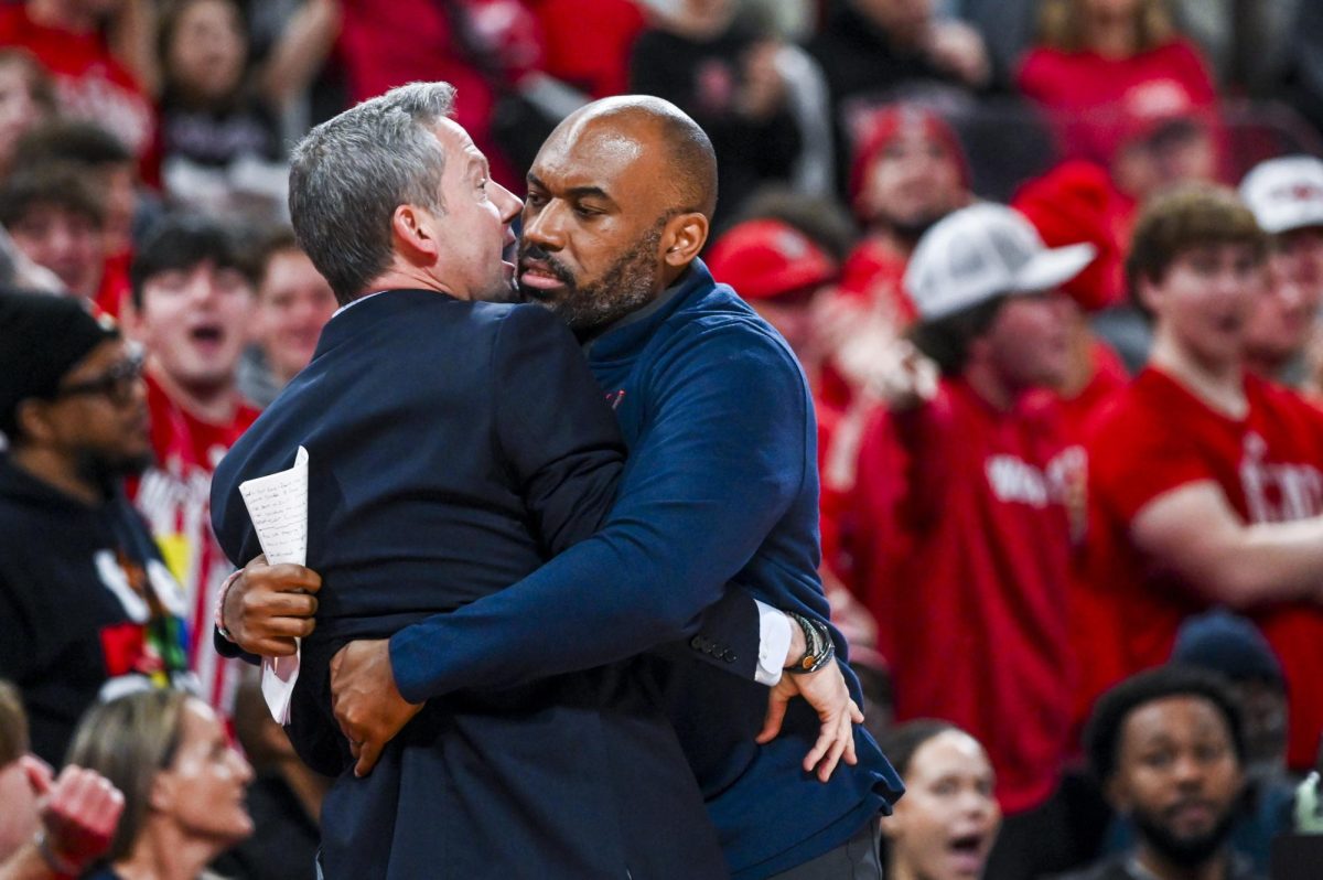 Virginia head coach Ryan Odom gets held back by assistant coach Bryce Crawford after receiving a technical foul during the game against NC State at the Lenovo Center on Saturday, Jan. 3, 2026. The Cavaliers beat the Wolfpack 76-61.