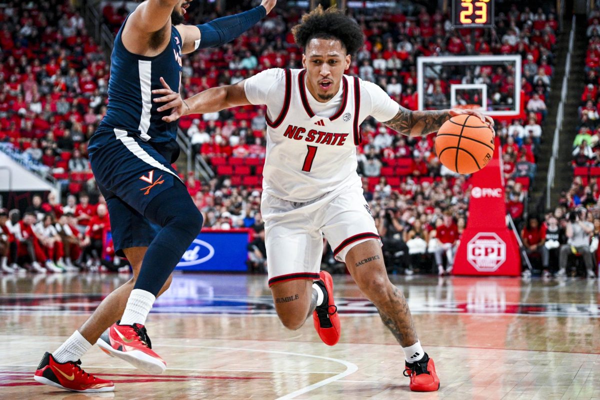 Senior forward Darrion Williams makes a drive during the game against Virginia at the Lenovo Center on Saturday, Jan. 3, 2026. Williams scored a total of seven points. The Cavaliers beat the Wolfpack 76-61.