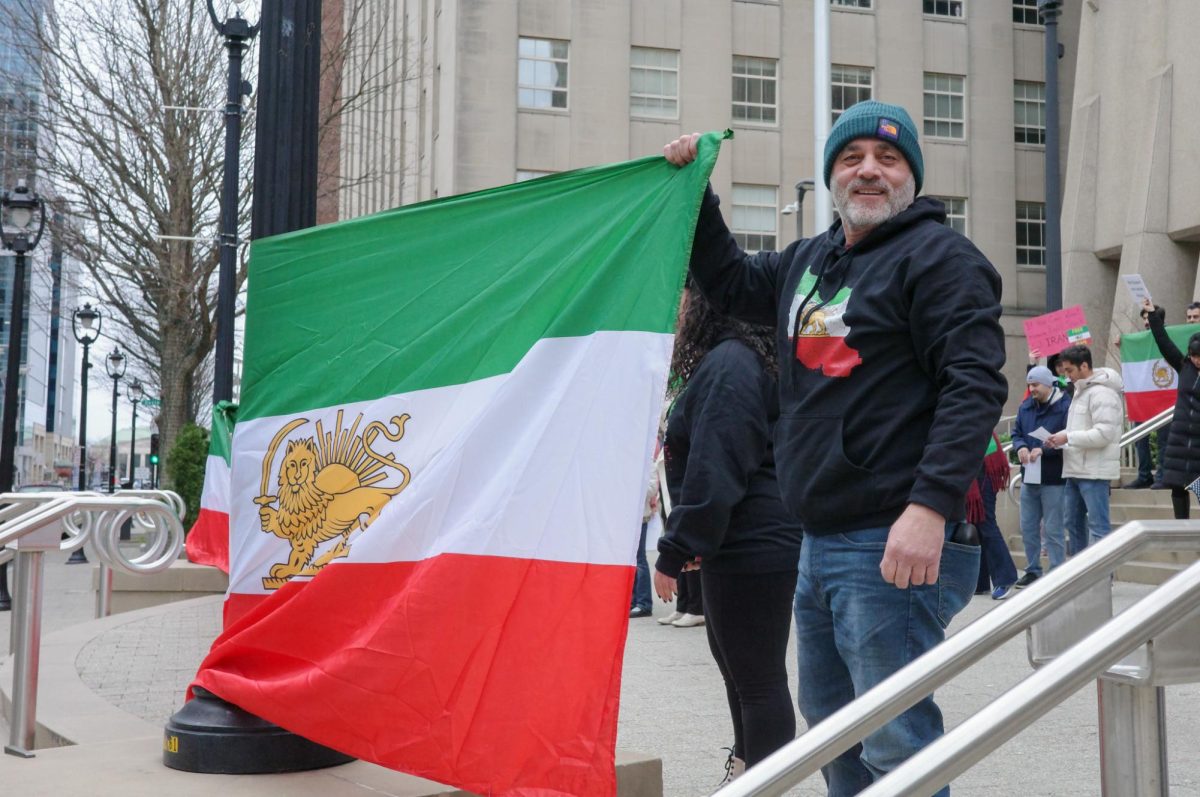 Farhad Hafshejai holds a flag in front of the Wake County Courthouse on Saturday, Jan. 17, 2026. This protest was organized to support the people of Iran amidst ongoing widespread protests in the country.
