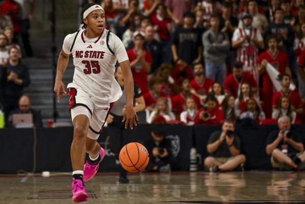 Junior guard Zoe Brooks drives the ball down the court during the game against Louisville in Reynolds Coliseum on Sunday, Jan. 18, 2026. The Wolfpack was defeated by the Cardinals 88-80 after going into overtime.