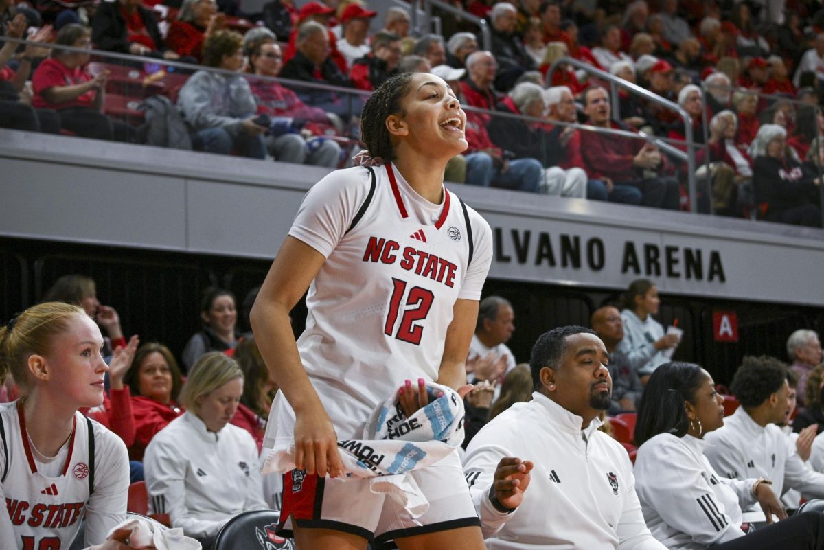 Junior forward Khamil Pierre cheers from the bench during the game against SMU in Reynolds Coliseum on Sunday, Jan. 11, 2026. Pierre scored 14 points and had 12 rebounds. The Wolfpack defeated the Mustangs 90-54.