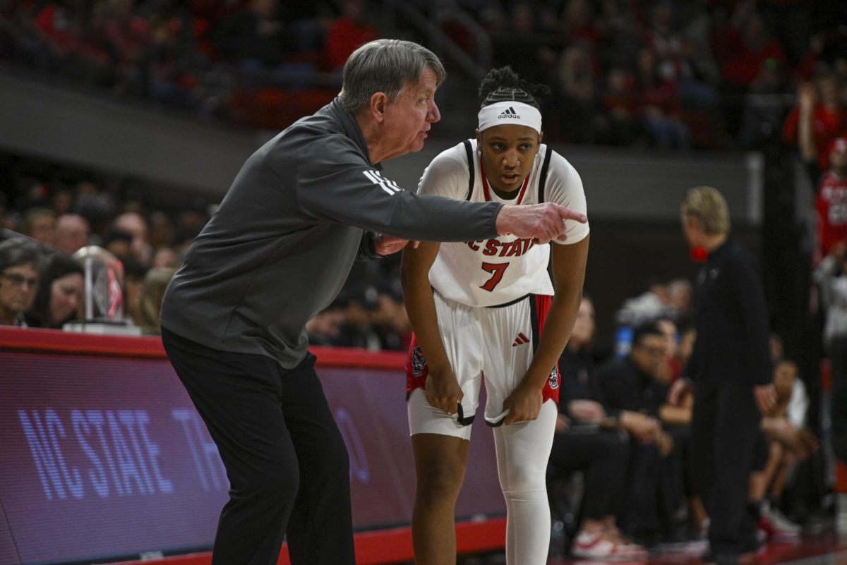 Freshman guard Destiny "Ky'She" Lunan speaks with coach Moore during the game against Stanford at Reynolds Coliseum on Thursday, Jan 01, 2026. Lunan scored a total of seven points. The Wolfpack defeated the Cardinals 74-46.
