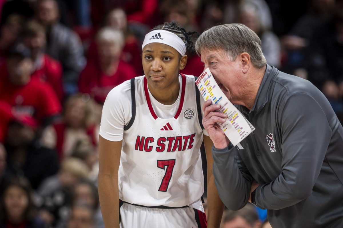 Head coach Wes Moore coaches freshman guard Destiny Lunan during the game against Stanford in Reynolds Coliseum on Thursday, Jan. 1, 2026. The Wolfpack defeated the Cardinal 74-46.