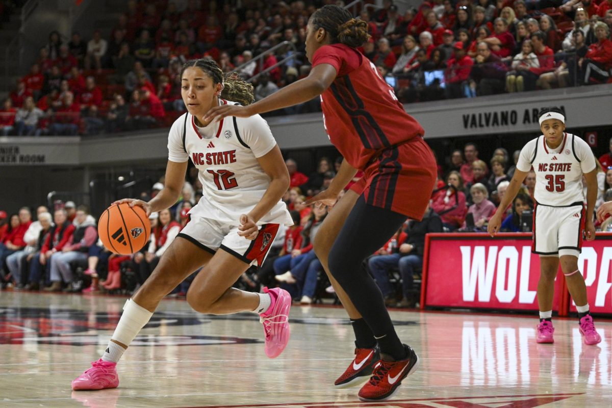 Junior forward Khamil Pierre dribbles the ball during the game against Stanford at Reynolds Coliseum on Thursday, Jan. 1, 2026. Pierre scored a total of 10 points. The Wolfpack defeated the Cardinals 74-46.