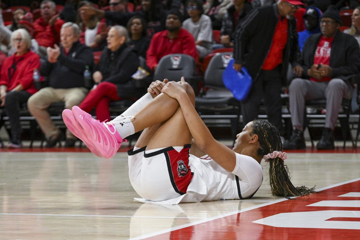 Junior forward Khamil Pierre falls during the game against Stanford at Reynolds Coliseum on Thursday, Jan. 1, 2026. Pierre scored a total of 10 points. The Wolfpack defeated the Cardinals 74-46.