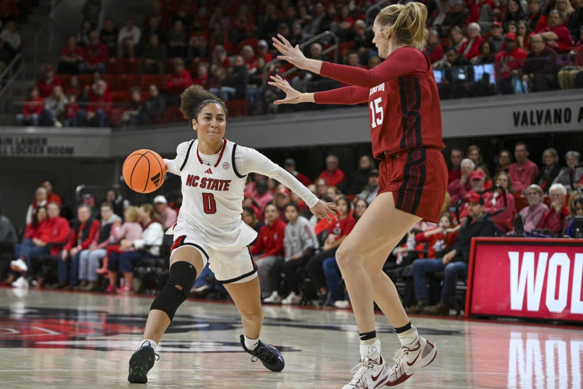 Sophomore guard Devyn Quigley passes the ball during the game against Stanford at Reynolds Coliseum on Thursday, Jan. 1, 2026. Quigley scored a total of three points. The Wolfpack defeated the Cardinals 74-46.