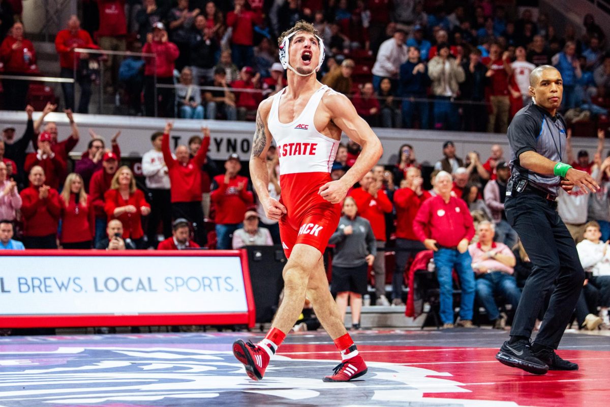 Sixth-year Zach Redding screams after winning his match against Ethan Oakley during the wrestling match against UNC-Chapel Hill in Reynolds Coliseum on Friday, Jan. 23, 2026. Redding won the 133 bout over #18 Oakley 8-2. The Wolfpack beat the Tar Heels 24-10