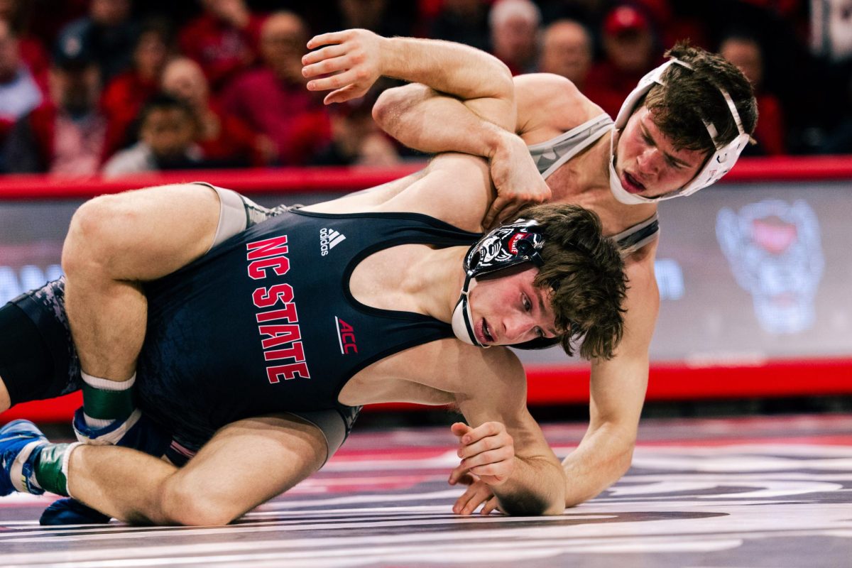 Redshirt sophomore Koy Buesgens grapples during his wrestling match against Virginia Tech in Reynolds Coliseum on Friday, Jan. 30, 2026. The Hokies beat the Wolfpack 21-12.
