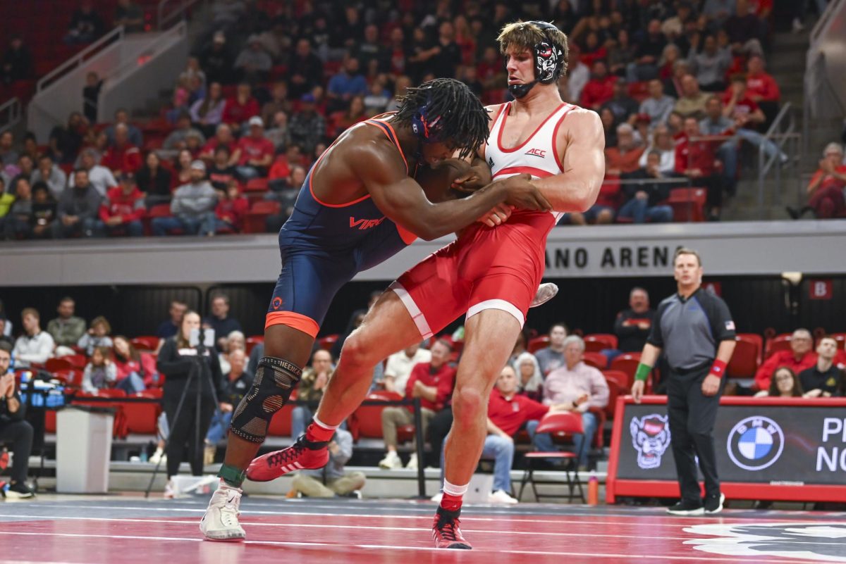 Redshirt sophomore Patrick Brophy tries to trip his opponent during the wrestling match against Virginia in Reynolds Coliseum on Friday, Jan. 9, 2026. NC State beat Virginia 19-17.