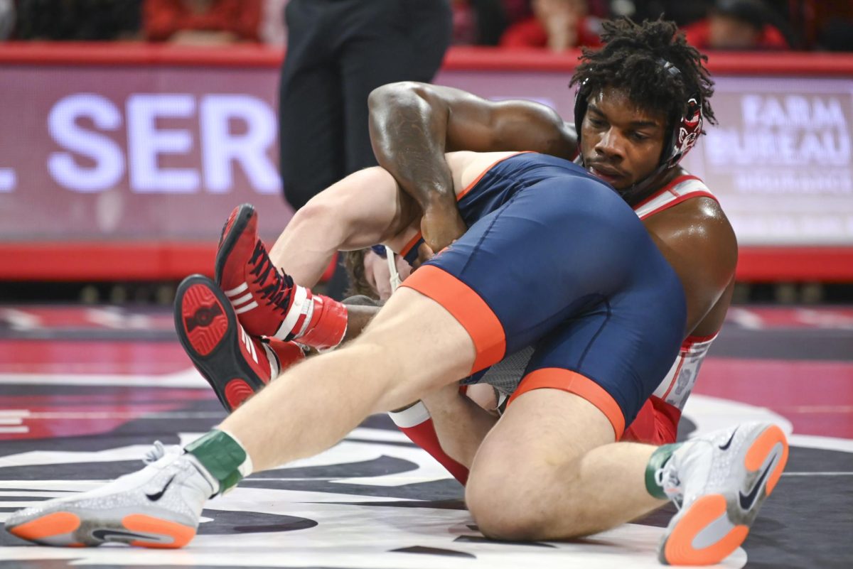 Sixth-year wrestler Don Cates grapples his opponent during the wrestling match against Virginia in Reynolds Coliseum on Friday, Jan. 9, 2026. Cates won the 184 bout 17-12. NC State beat Virginia 19-17.