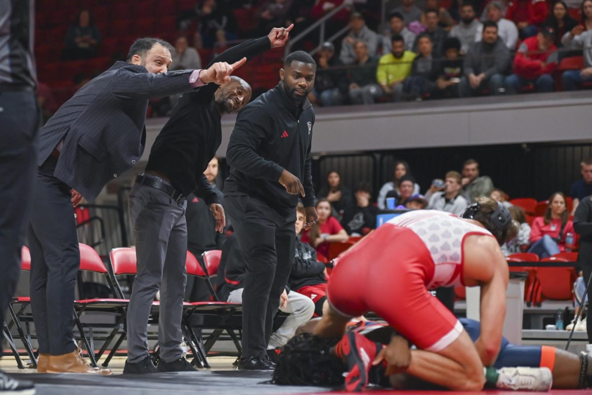 NC State wrestling coaches tries to direct redshirt sophomore Patrick Brophy during the wrestling match against Virginia in Reynolds Coliseum on Friday, Jan. 9, 2026. NC State beat Virginia 19-17.