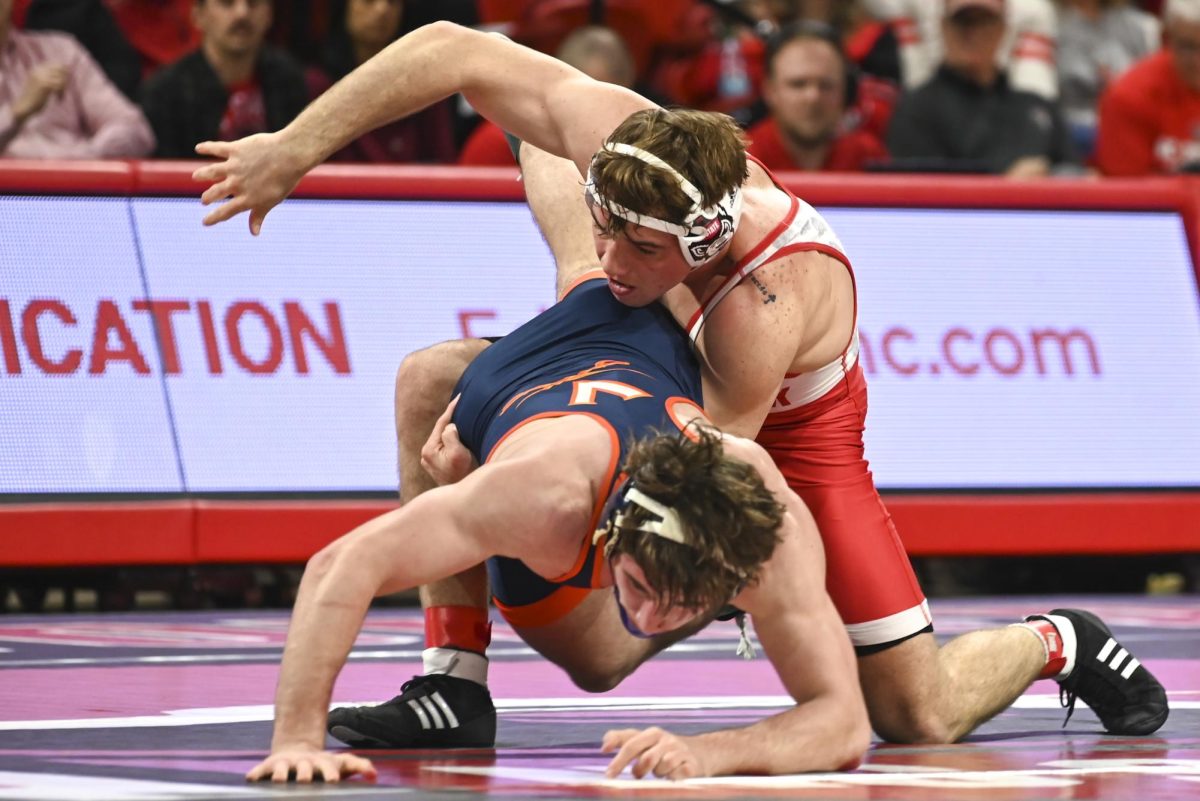 Freshman Will Denny prepares to takedown his opponent during the wrestling match against Virginia in Reynolds Coliseum on Friday, Jan. 9, 2026. Denny won the 165 by major decision bout 9-1. NC State beat Virginia 19-17.