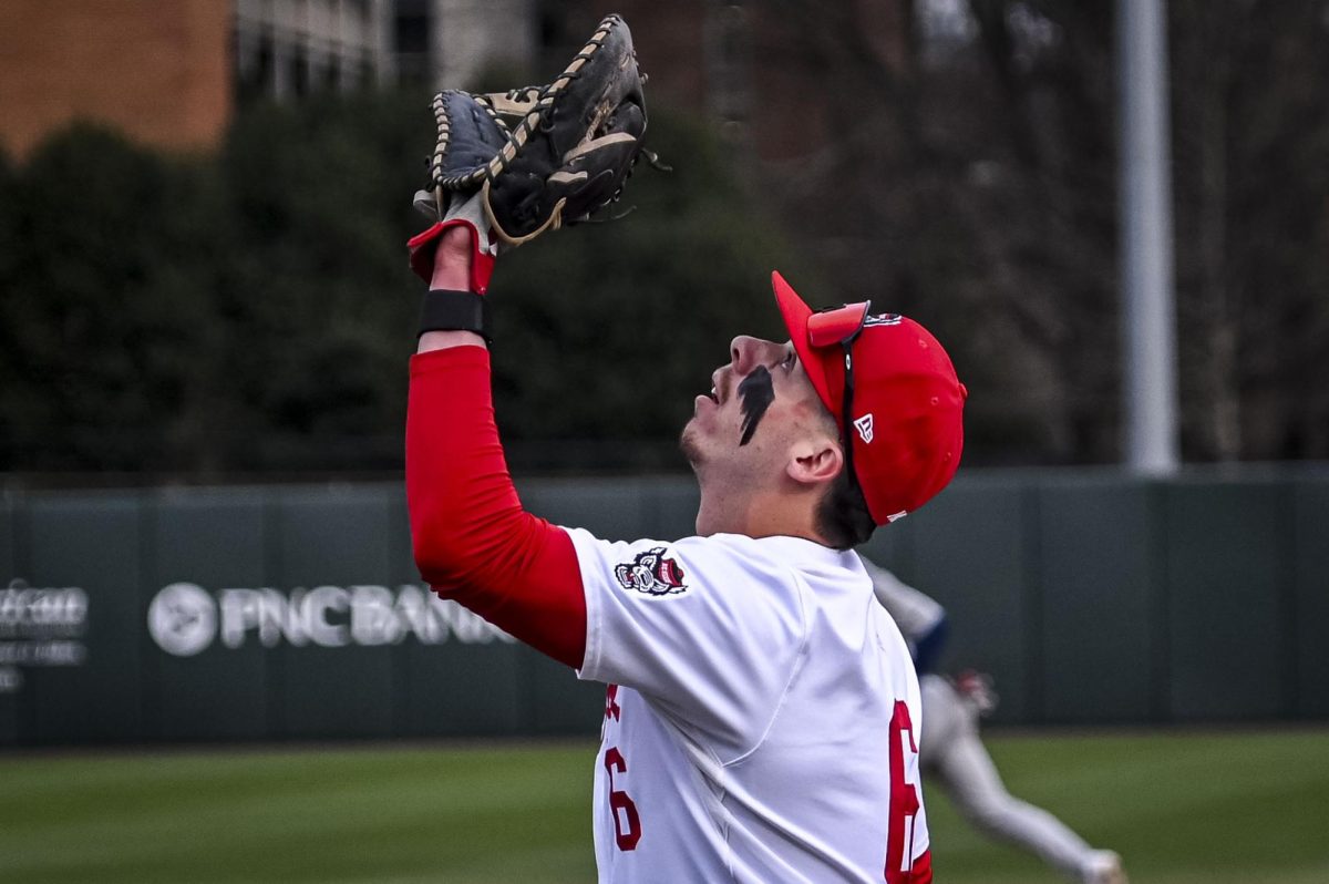 Senior infielder Dalton Bargo catches a fly ball at first base during the game against Richmond at Doak Field in Dail Park on Tuesday, Feb. 24, 2026. The Wolfpack defeated the Spiders 27-0.