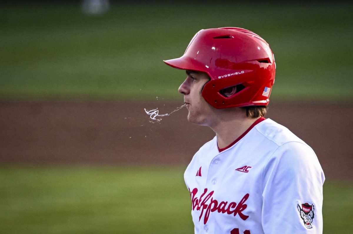 Redshirt-freshman catcher Preston Bonn spits during the game against Richmond at Doak Field in Dail Park on Tuesday, Feb. 24, 2026. The Wolfpack defeated the Spiders 27-0.