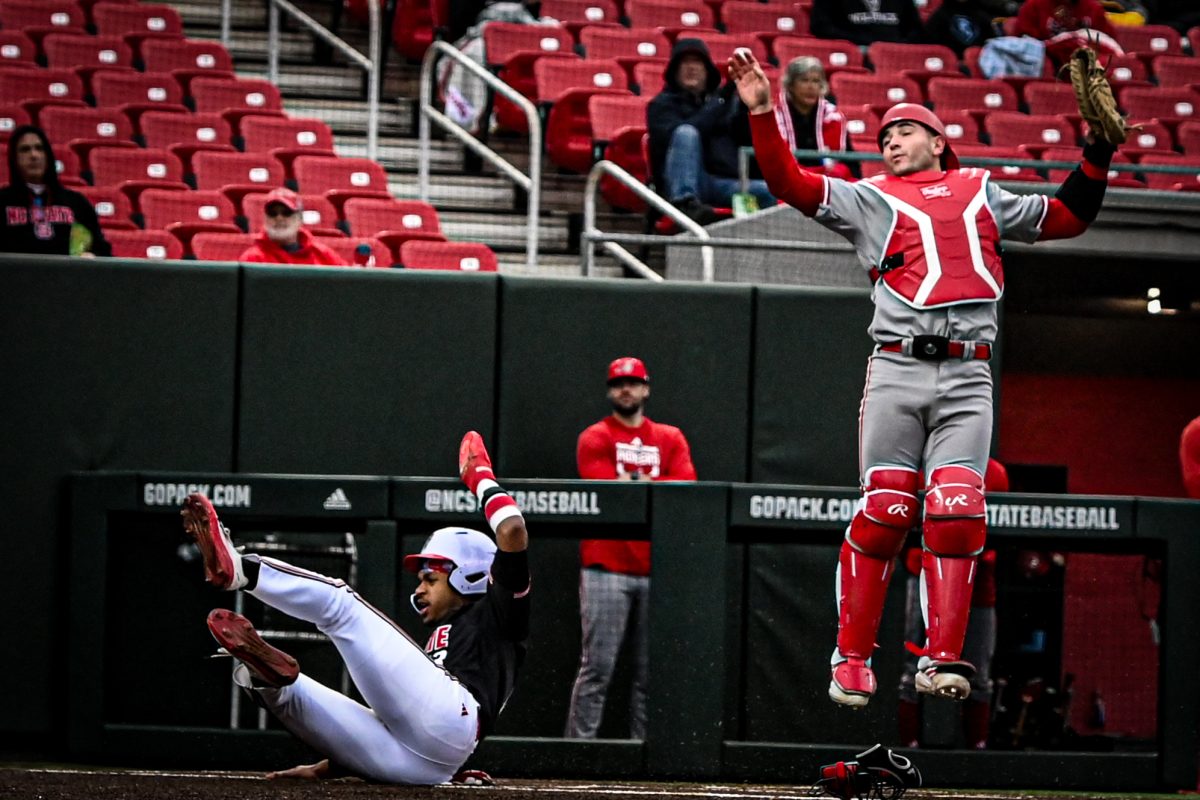 NC State junior outfilder Andrew Wiggins dives for home base during the game against Sacred Heart in Doak Field at Dail Park on Friday, Feb. 27, 2026. The Wolfpack defeated the Pioneers 17-4.