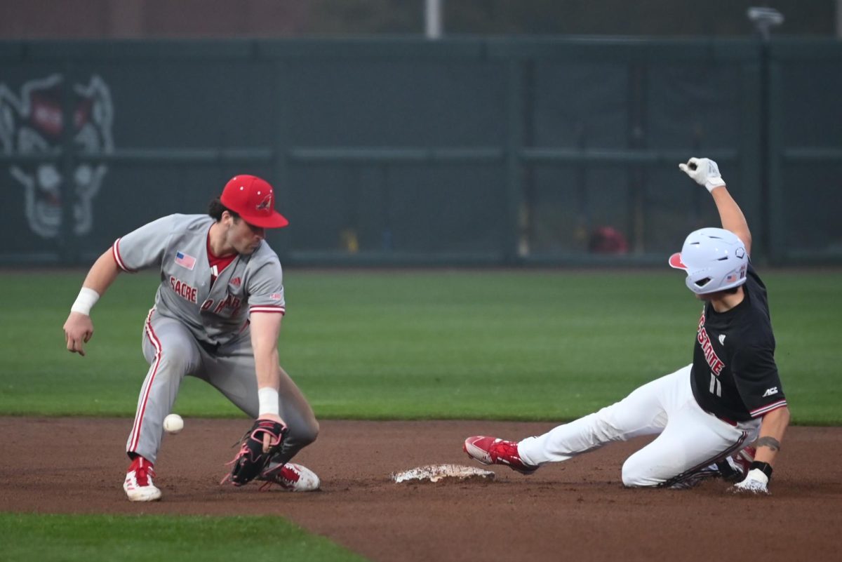 Redshirt freshman catcher Preston Bonn slides into second before the tag by junior utility Gavin Donohue during the game against Sacred Heart in Doak Field at Dail Park on Friday, Feb. 27, 2026. The Wolfpack defeated the Pioneers 17-4 in seven innings.