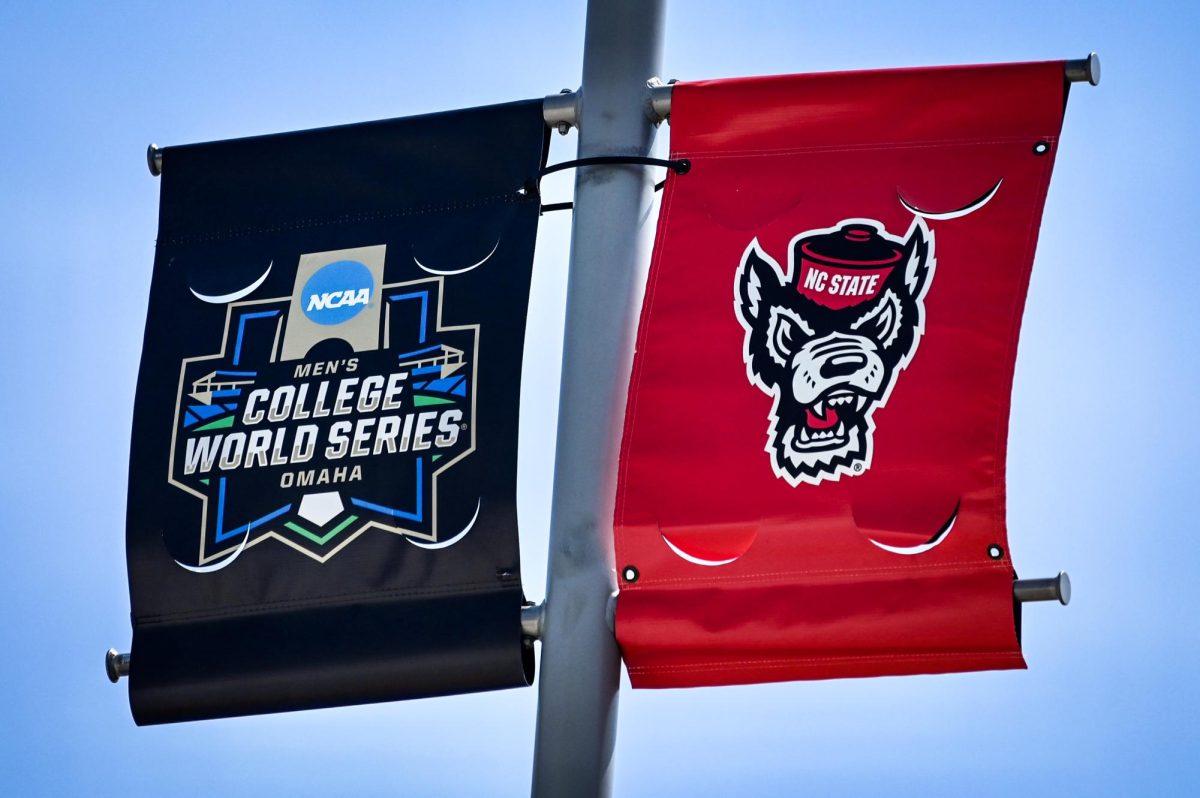 The NC State Wolfpack banner hangs next to the Men's College World Series banner on the Charles Schwab Field in Omaha, Nebraska on Monday, June 17, 2024.