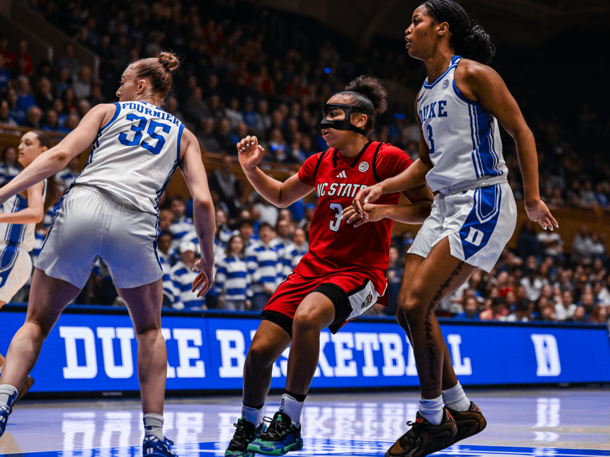 Sophomore guard Zam Jones looks toward the play as she moves around a Duke defender during the game against the Blue Devils on Thursday, Feb. 19, 2026, at Cameron Indoor Stadium. Jones added four assists for the Wolfpack. NC State fell to Duke 83–65.