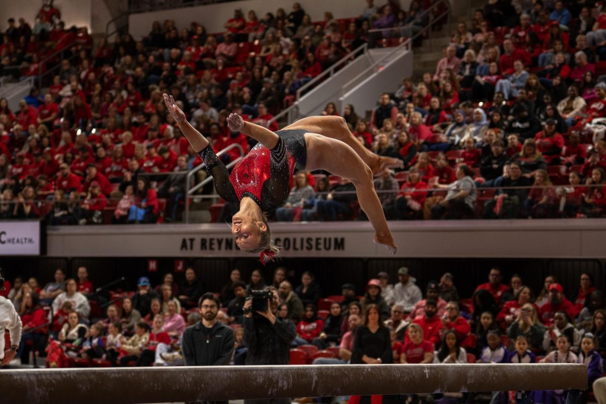 Junior Katie Harper goes into a flip on the beam during the meet against UNC at Reynolds Coliseum on Sunday, Feb. 8, 2025. Harper scored a 9.850 on her beam routine. NC State beat UNC 197.125-196.525.