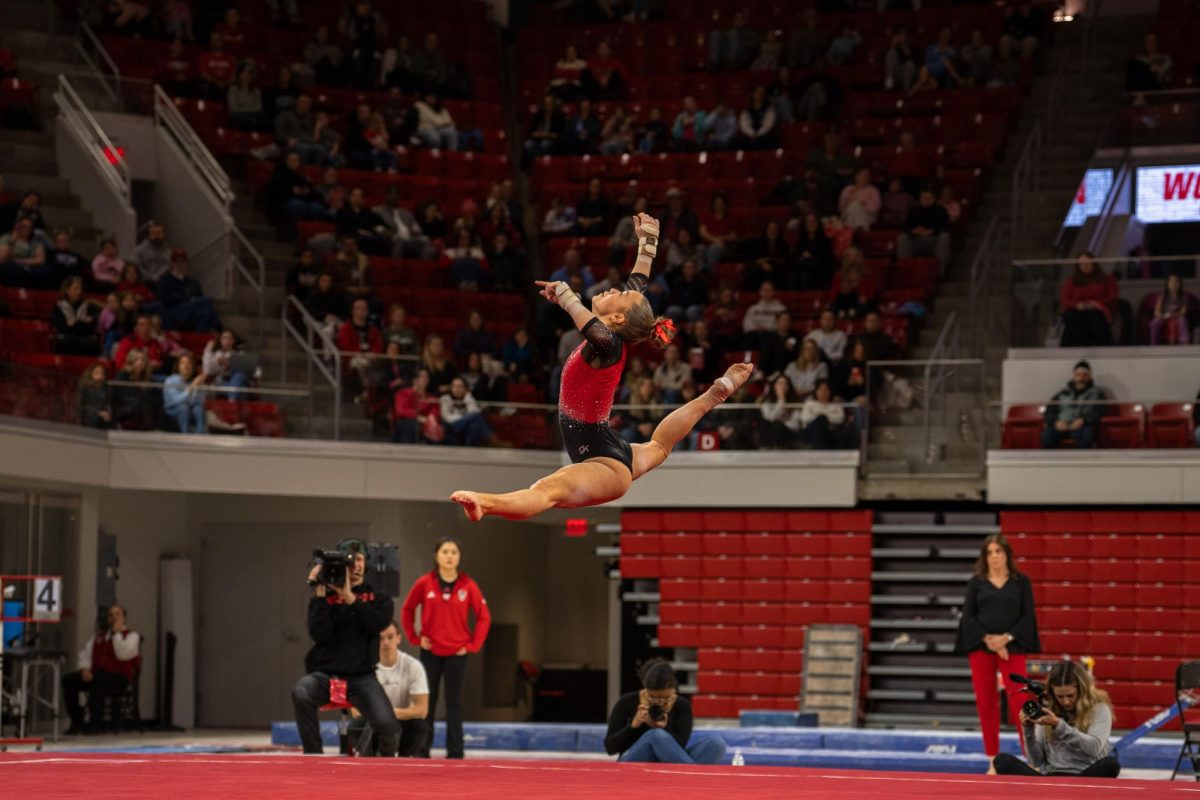 Sophomore Jenna Rusk jumps up in the air during her floor routine at the meet against UNC at Reynolds Coliseum on Sunday, Feb. 8, 2025. Rusk scored a 9.850 on her floor routine. NC State beat UNC 197.125-196.525.