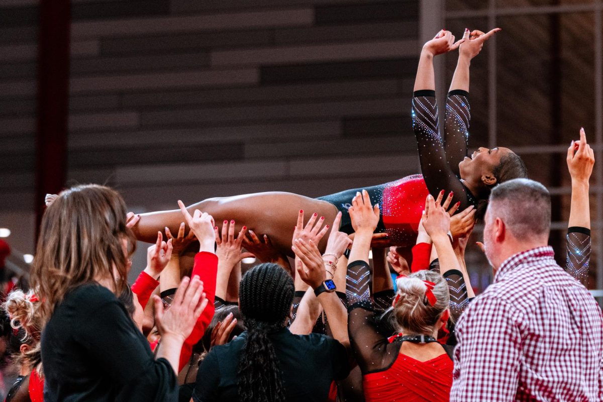 Sophomore Syniya Thomas is lifted by her teammates after winning the meet against UNC at Reynolds Coliseum on Sunday, Feb. 8, 2025. Thomas scored 9.975 on her floor routine. Thomas earning a 9.975, tied the second-highest floor score in program history and the first 9.975 by a Pack gymnast since Chloe Negrete on March 7, 2025. The Wolfpack beat the Tar Heels 197.125-196.525.