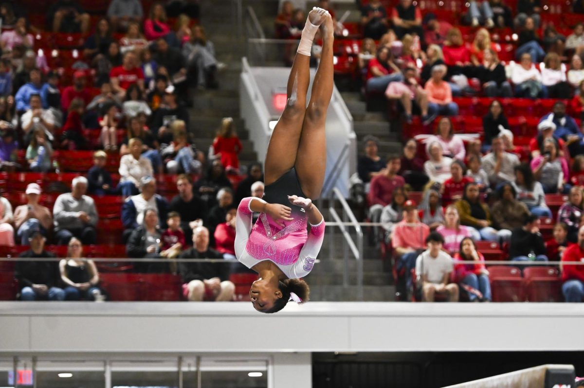 Sophomore Syniya Thomas dismounts from the beam during the pink meet versus Stanford at R.J. Reynolds Coliseum on Saturday, Feb. 21, 2026. NC State lost 197.725-196.575 to Stanford. 