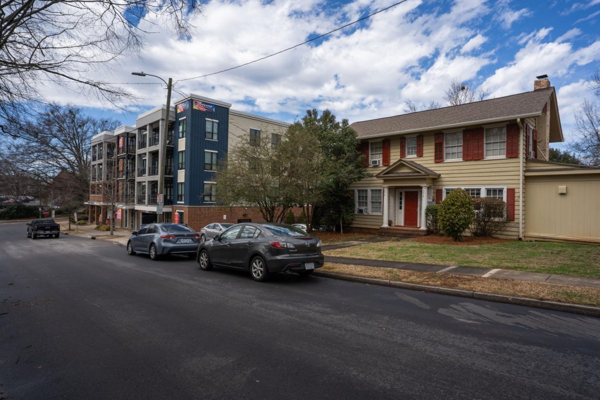 A house sits next to an apartment complex developed in 2019 on Hope Street.